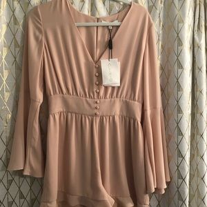 Never worn, with tags, beautiful Alexis romper!